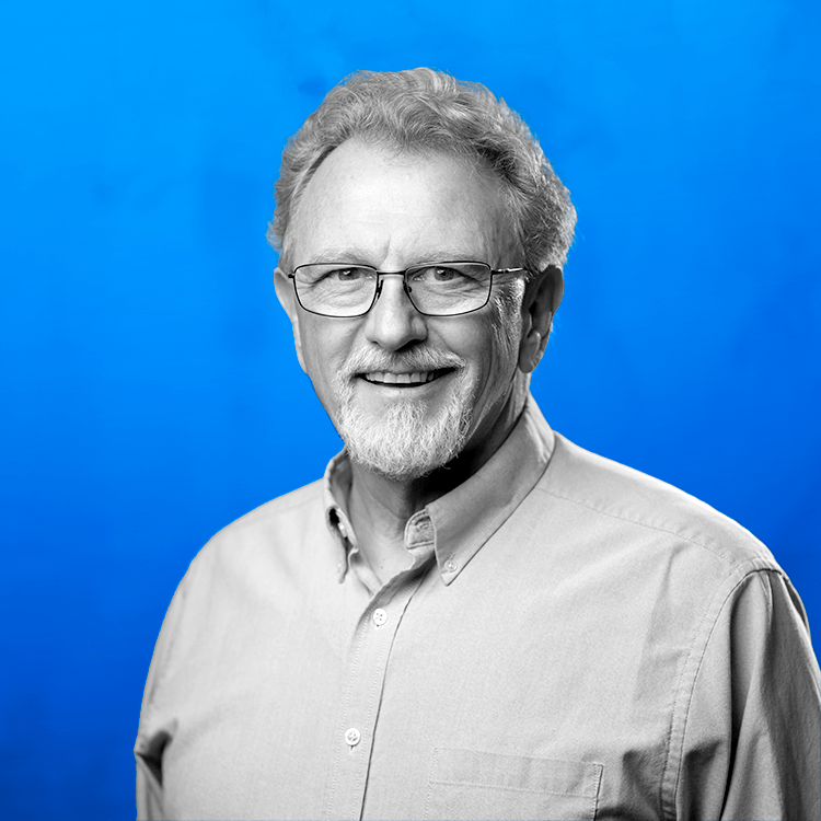 Headshot photo of Jonas Fitness' Client Success Manager, Barry Bleuer, standing in front of a blue background.