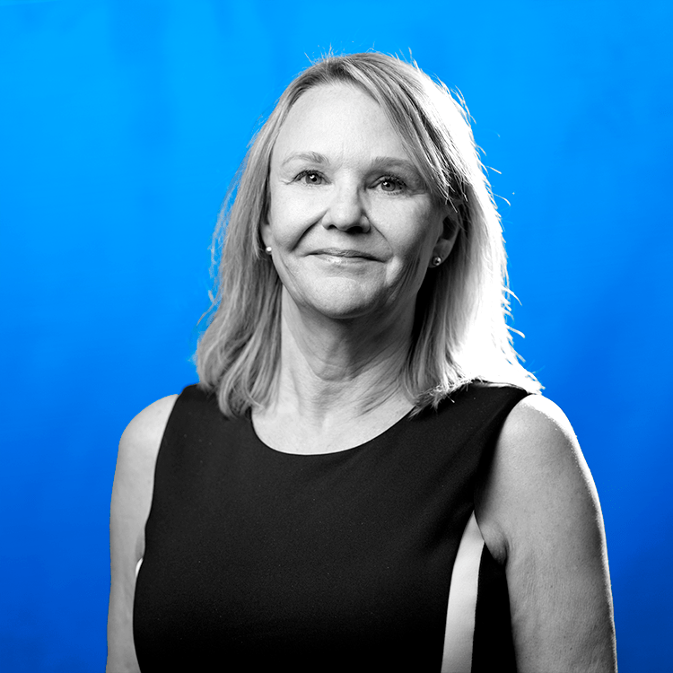 Headshot photo of Jonas Fitness' Implementation Specialist Manager, Delene Rau, standing in front of a blue background.