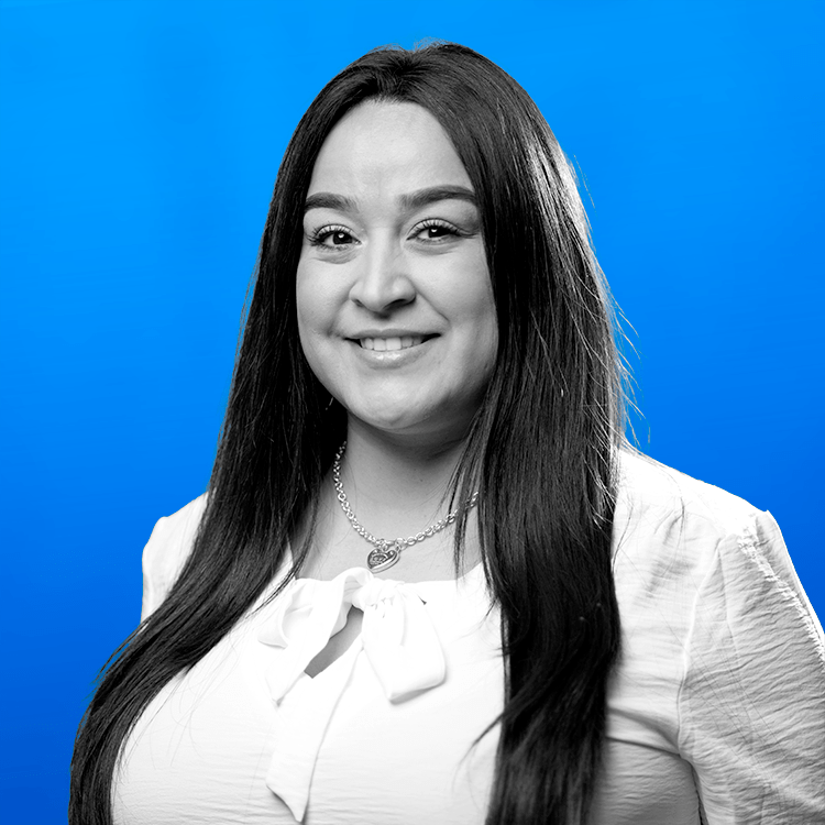 Headshot photo of Jonas Fitness' Director of Payments and MBS, Eleanor Gracia, standing in front of a blue background.
