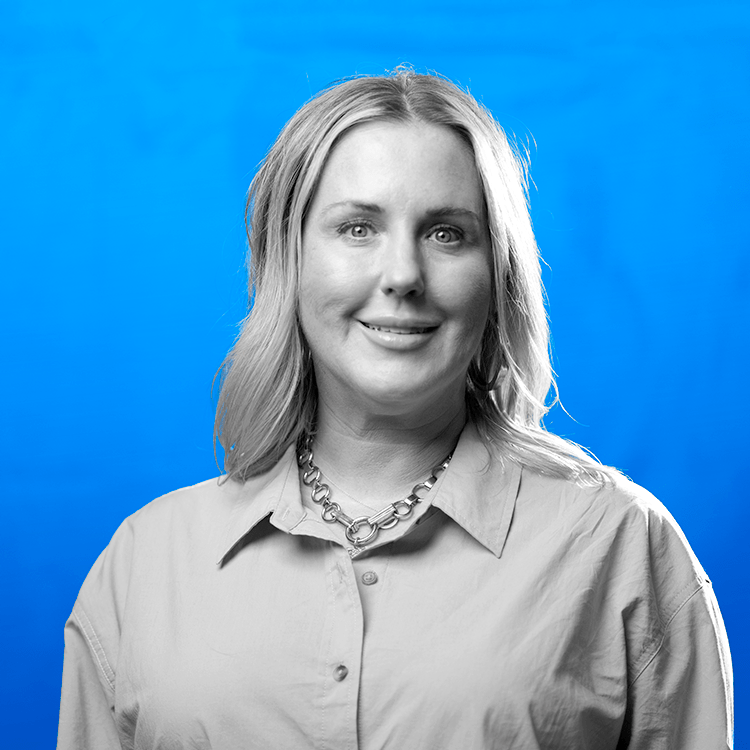 Headshot photo of Jonas Fitness' Client and Partner Success Manager, Merissa Williams, standing in front of a blue background.